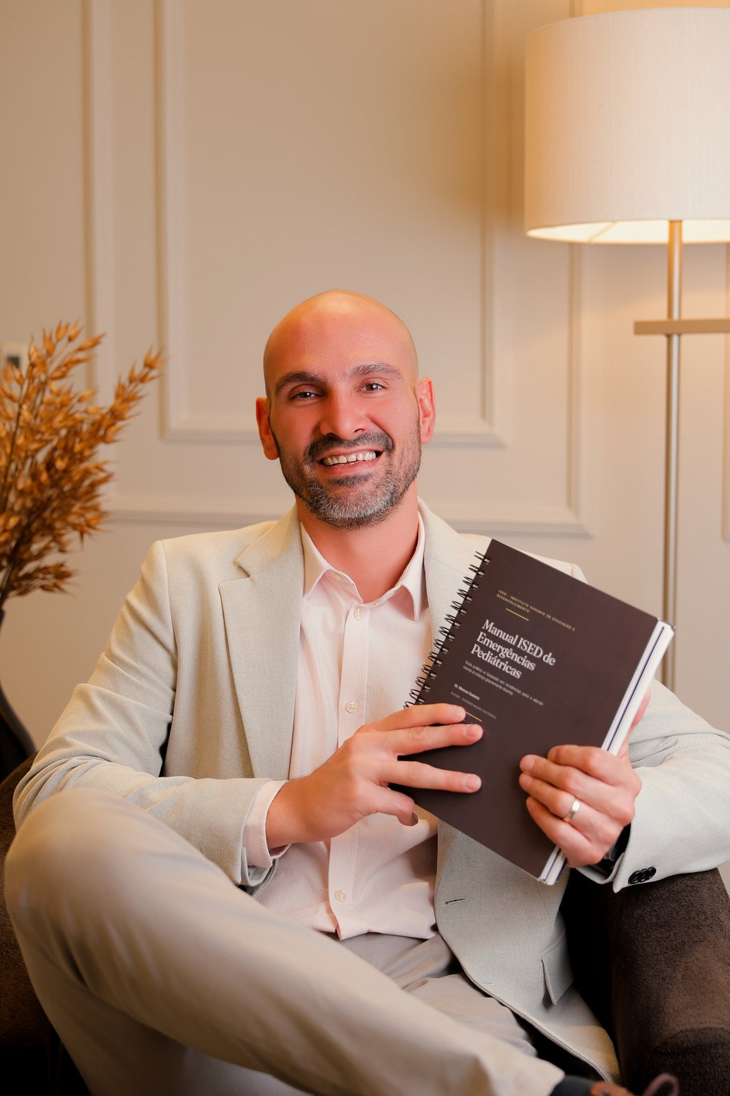 Dr. Marcos Sudario com o Manual ISED de Emergências Pediátricas em mãos